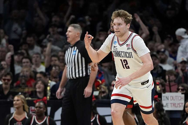 UConn guard Cam Spencer (12) celebrates after hitting a 3-pointer during the first half of the Sweet 16 college basketball game against San Diego State in the men's NCAA Tournament, Thursday, March 28, 2024, in Boston. (AP Photo/Michael Dwyer)