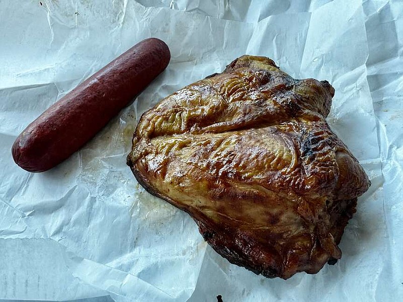 Weldon's Meat Market's oak smoked hot link and bone-in smoked chicken breast is shown. Weldon's Meat Market also has smoked Polish sausages and ribs. (The Sentinel-Record/Bryan Rice)