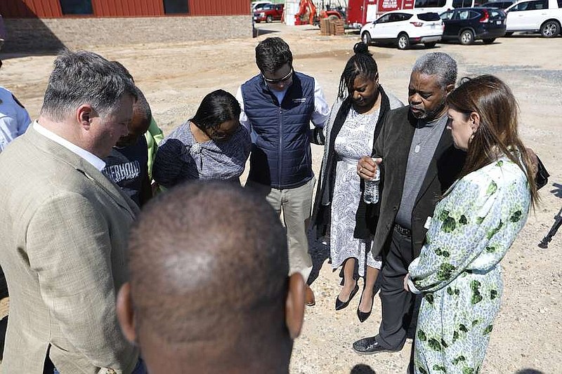 Gov. Sarah Huckabee Sanders (right) and Pastor Eddie Miller (second from right), pastor of New Commandment Church of God in Christ, hold a prayer circle with church members, and state and local elected officials in commemoration of the one year anniversary of last year's March 31 on Friday, March 29, 2024, at the church's new location in Jacksonville. (Arkansas Democrat-Gazette/Thomas Metthe)
