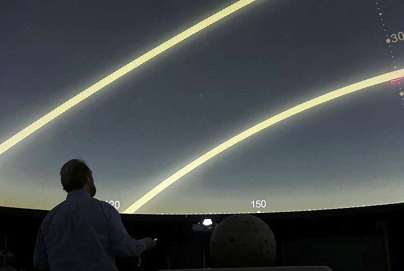 Planetarium Director Mark Percy leads a lesson at the Williamsville North High School planetarium in Williamsville, N.Y., on March 18, 2024, in preparation for the upcoming total solar eclipse. Teachers in or near the path of totality say they have worked to come up with educational and engaging lessons for the rare event. (AP Photo/Carolyn Thompson)