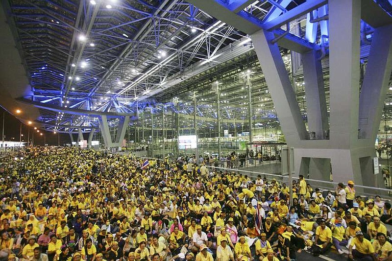 FILE - Anti government protesters sits in front of the departure terminal at Suvarnabhumi airport, Bangkok in the early hours of Wednesday Nov. 26, 2008. A Thai court on Friday, March 29, 2024, acquitted nearly 70 people of all charges related to mass protests that shut down Bangkok's two airports in 2008. Members of the same group, opposed to a government headed that year by political allies of ousted former Prime Minister Thaksin Shinawatra, also briefly seized a state television station and occupied the Government House for three months. (AP Photo/Sakchai Lalit, File)