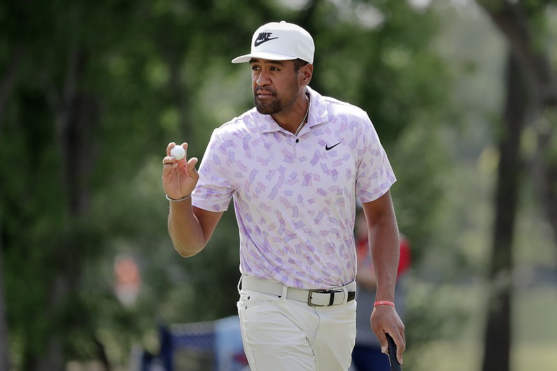 Defending champion Tony Finau acknowledges the gallery after sinking his putt on the eighth green during the first round of the Houston Open golf tournament Thursday, March, 28, 2024, in Houston. (AP Photo/Michael Wyke)