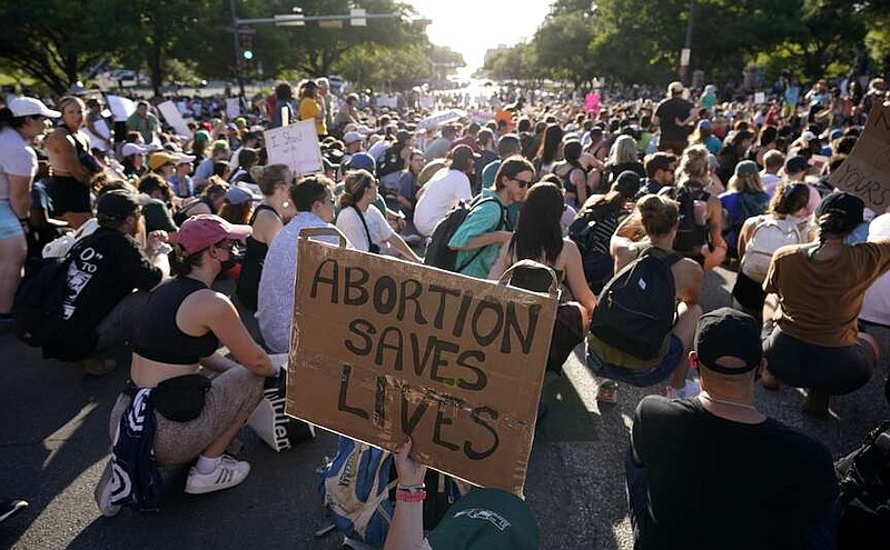 FILE - Demonstrators march and gather near the Texas Capitol following the U.S. Supreme Court's decision to overturn Roe v. Wade, June 24, 2022, in Austin, Texas. Lizelle Gonzalez, a Texas woman who was charged with murder over self-managing an abortion and spent two nights in jail, sued prosecutors Thursday, March 28, 2024, along the U.S.-Mexico border who put the criminal case in motion before it was later dropped. (AP Photo/Eric Gay, File)