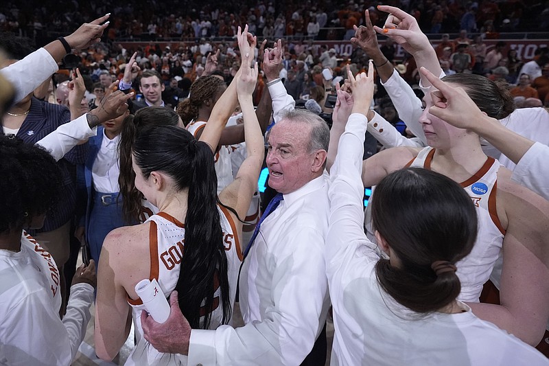 Texas head coach Vic Schaefer, center, celebrates with his team after their win over Alabama in a second-round college basketball game in the women's NCAA Tournament in Austin, Texas, Sunday, March 24, 2024. (AP Photo/Eric Gay)