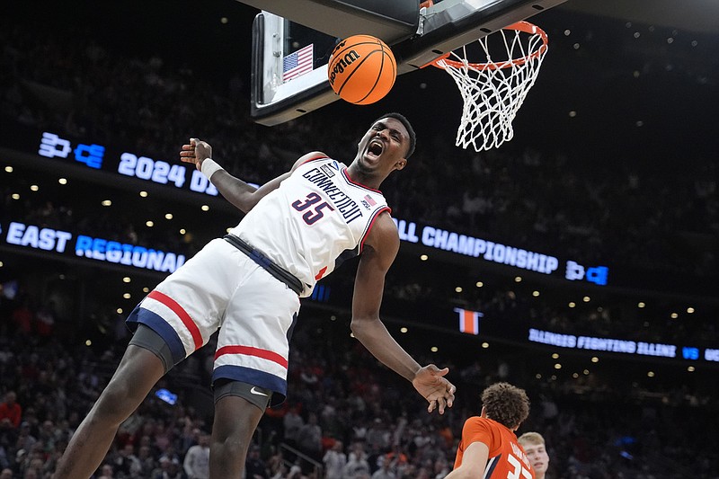 UConn forward Samson Johnson celebrates after his dunk against Illinois during the first half of the Elite 8 college basketball game in the men's NCAA Tournament, Saturday, March 30, 2024, in Boston. (AP Photo/Steven Senne)