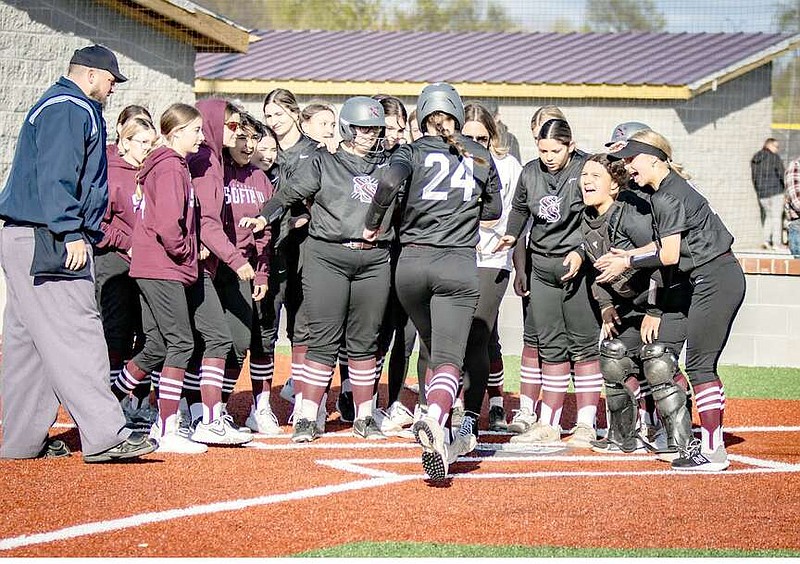 Photo courtesy of Krystal Elmore Kaidence Prendergast of Siloam Springs is met at home plate by her teammates after hitting a home run against Alma on March 26.