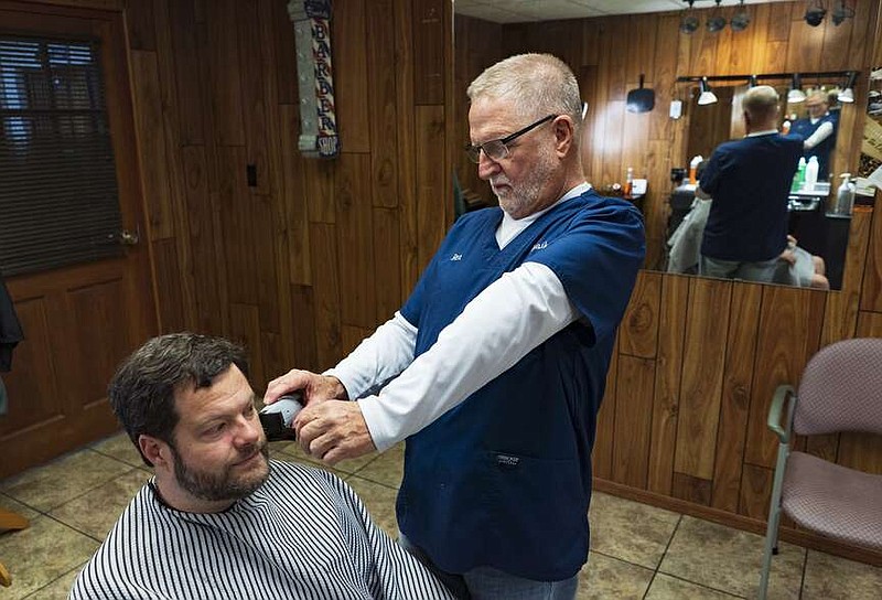 Rex Bailey (right) trims the beard of Blake Chapman of Springdale on Thursday at Bailey's Barber & Style Shoppe in Springdale. Bailey, longtime City Council member and downtown businessman, is retiring and closed his barber shop as of Thursday. Visit nwaonline.com/photos for today's photo gallery.

(NWA Democrat-Gazette/Charlie Kaijo)