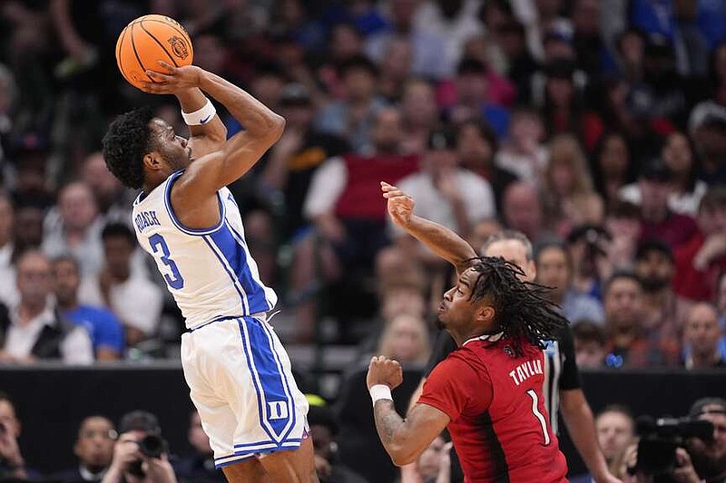 Duke's Jeremy Roach (3) shoots against North Carolina State's Jayden Taylor (1) during the first half of an Elite Eight college basketball game in the NCAA Tournament in Dallas, Sunday, March 31, 2024. (AP Photo/Tony Gutierrez)
