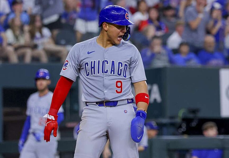 Chicago Cubs' Miguel Amaya celebrates after scoring on a two-run double from Ian Happ during the fourth inning of a baseball game against the Texas Rangers, Sunday, March 31, 2024, in Arlington, Texas. (AP Photo/Gareth Patterson)