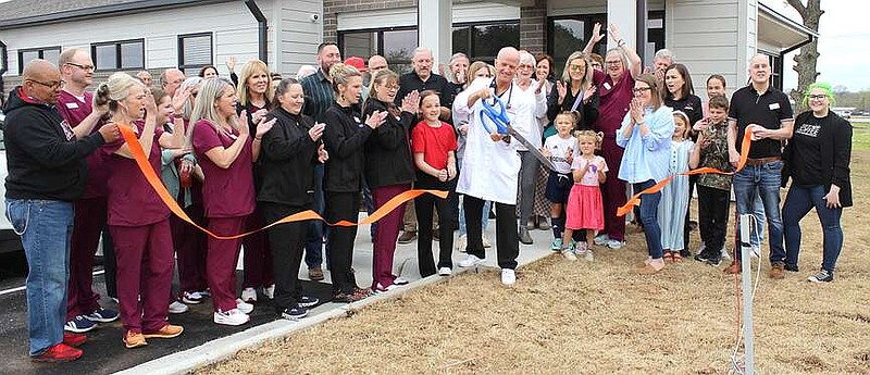Annette Beard/Pea Ridge TIMES
Dr. Alan Schumacher cuts the ribbon, celebrating the opening of the Pea Ridge Urgent Care clinic Saturday, March 30, 2024. Members of the staff and community joined for the celebration. For more photographs, go to the PRT gallery at https://tnebc.nwaonline.com/photos/.