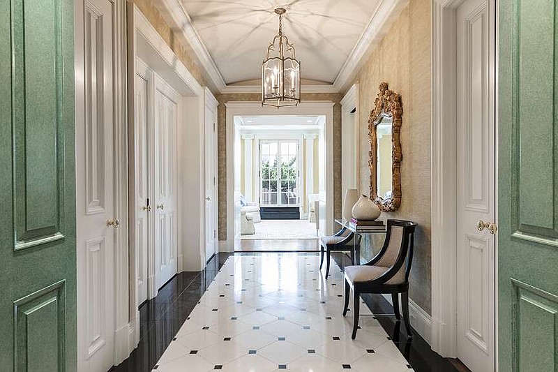A formal entry is made elegant and inviting through the addition of an ornate mirror and seating. (Handout/TNS)