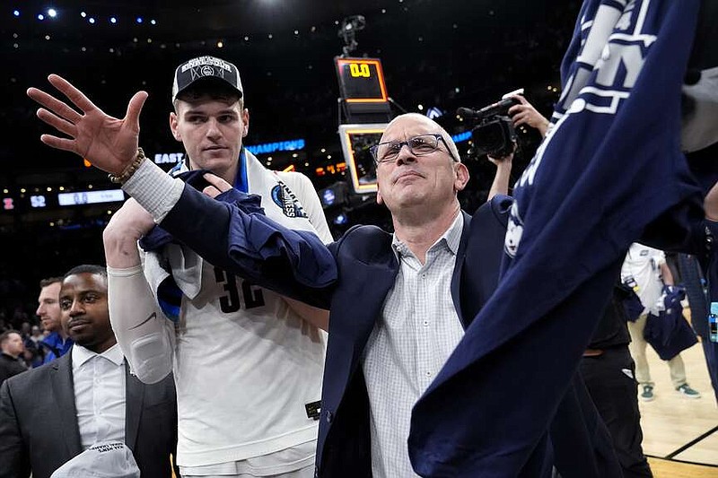 UConn head coach Dan Hurley celebrates with center Donovan Clingan, left, after defeating Illinois Saturday in Boston. (AP Photo/Michael Dwyer)