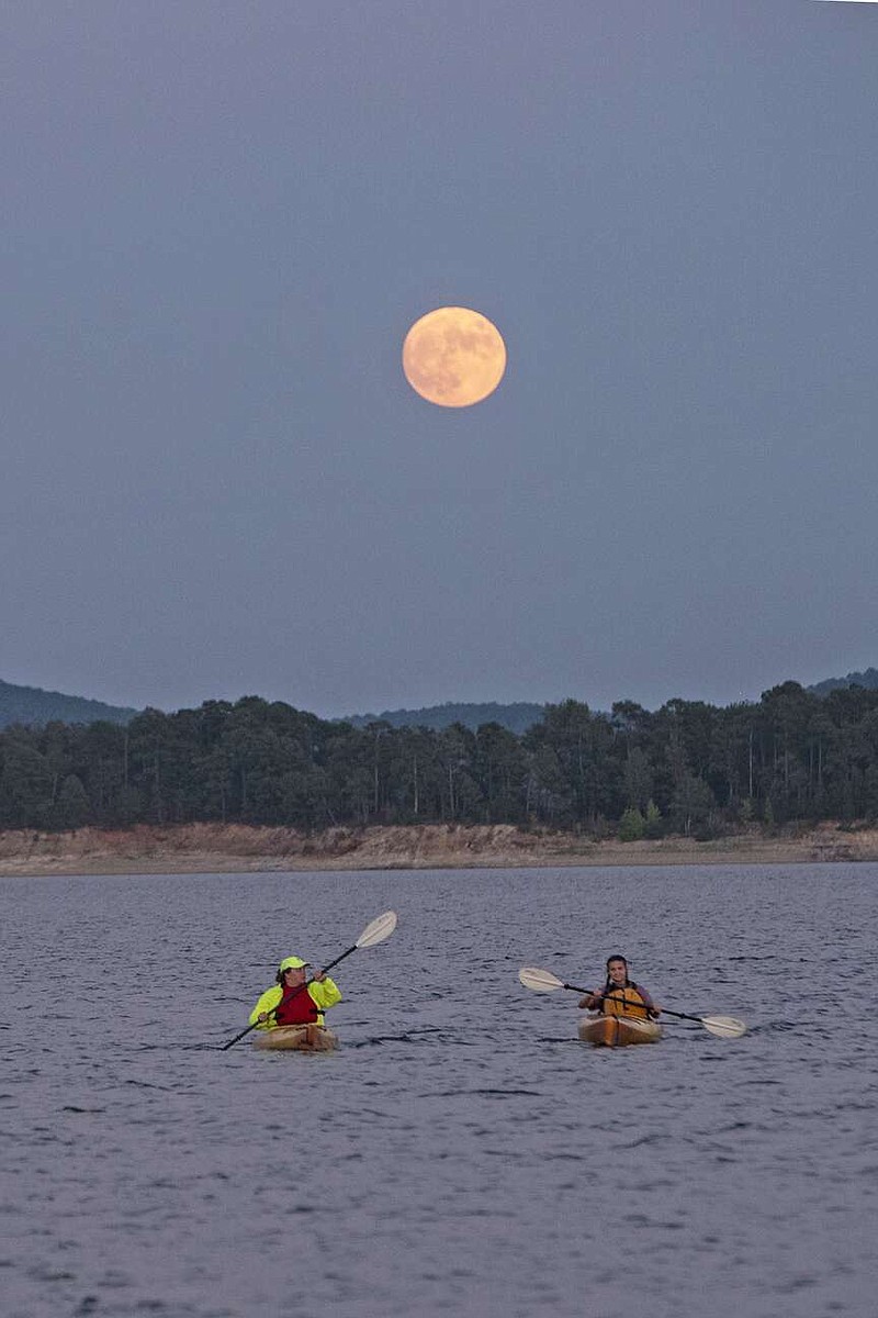 Kayakers paddle on Lake Ouachita under a full moon. Lake Ouachita State Park will be hosting a special stargazing event Friday and Saturday at the park in conjunction with NASA, the National Oceanic and Atmospheric Administration, Earth to Sky and the Hot Springs Village Stargazers Club. (Submitted photo courtesy of Arkansas Department of Parks, Heritage and Tourism)