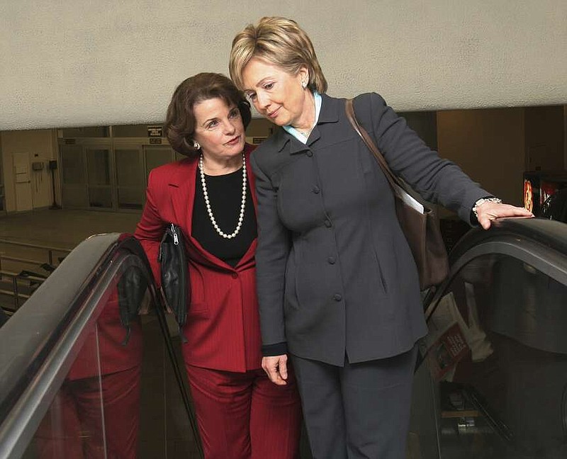 FILE - Sen. Hillary Rodham Clinton, D. N.Y., right, talks with Sen. Dianne Feinstein, D-Calif., on their way to vote on the Deficit Reduction Act, Wednesday, Dec. 21, 2005, on Capitol Hill in Washington. (AP Photo/Lauren Victoria Burke, File)