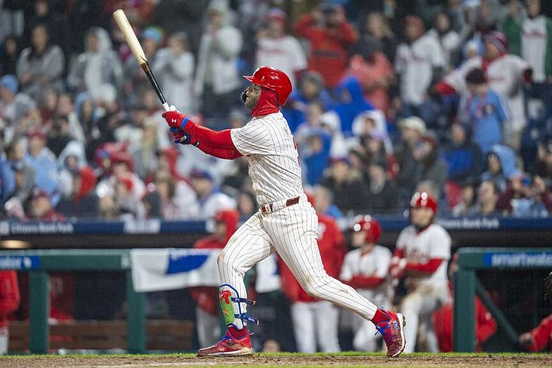 Philadelphia Phillies' Bryce Harper watches his grand slam during the seventh inning of the team's baseball game against the Cincinnati Reds, Tuesday, April 2, 2024, in Philadelphia. The Phillies won 9-4. (AP Photo/Chris Szagola)