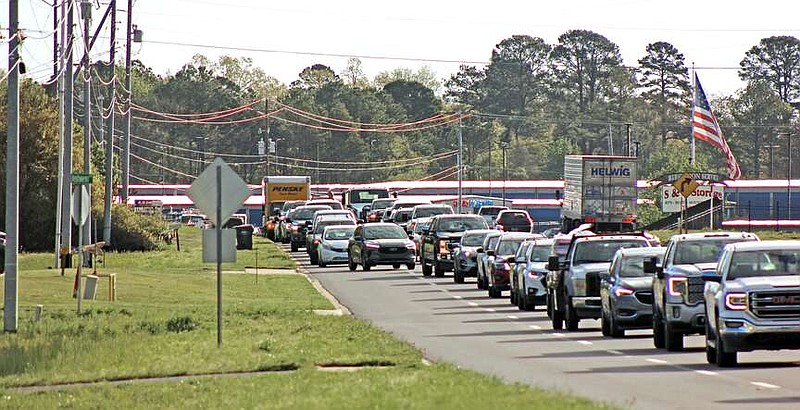 Westbound traffic is backed up Wednesday morning at the scene of a fatal collision in the 3200 block of Airport Road. (The Sentinel-Record/James Leigh)