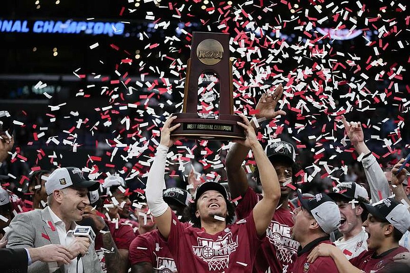 Alabama guard Mark Sears holds the winner's trophy after defeating Clemson in an Elite 8 college basketball game in the NCAA tournament Saturday, March 30, 2024, in Los Angeles. (AP Photo/Ashley Landis)