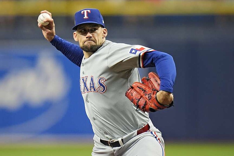 Texas Rangers starting pitcher Nathan Eovaldi delivers to the Tampa Bay Rays during the first inning of a baseball game Wednesday, April 3, 2024, in St. Petersburg, Fla. (AP Photo/Chris O'Meara)