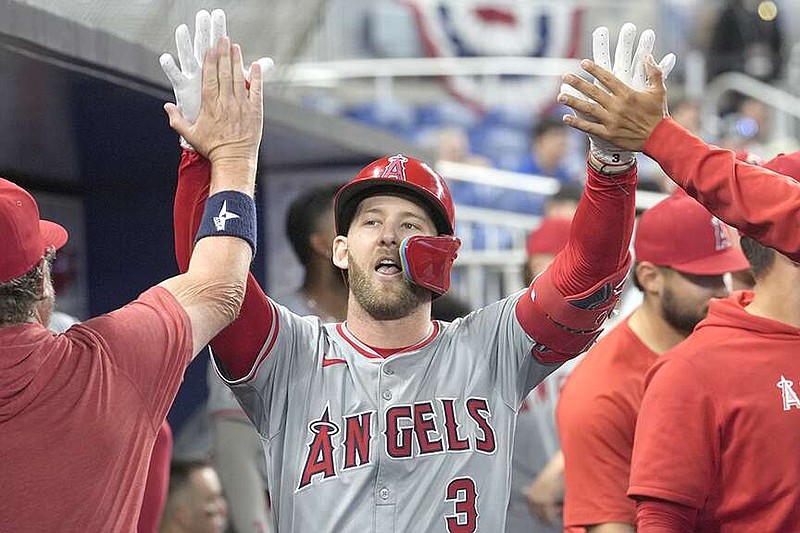 Teammates congratulate Los Angeles Angels' Taylor Ward (3) after hitting a home run during the eighth inning of a baseball game against the Miami Marlins, Wednesday, April 3, 2024, in Miami. The Angels defeated the Marlins 10-2. (AP Photo/Marta Lavandier)