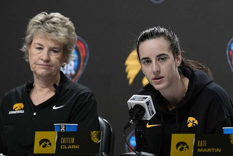 Iowa head coach Lisa Bluder and Caitlin Clark answer questions before a practice for an NCAA Women's Final Four semifinals basketball game Thursday, April 4, 2024, in Cleveland. (AP Photo/Morry Gash)