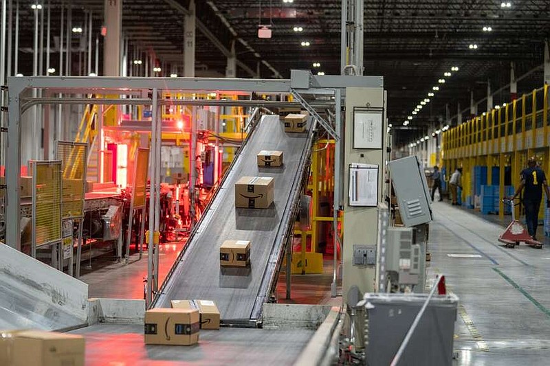 Packages move along a conveyor belt at an Amazon Fulfillment center in Robbinsville, N.J. MUST CREDIT: Jeenah Moon/Bloomberg.
