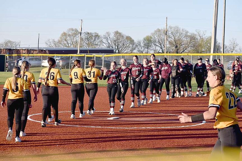 Mark Humphrey/Enterprise-Leader

Siloam Springs and Prairie Grove players line up to shake hands in a demonstration of sportsmanship after Thursday's nonconference softball game at Prairie Grove, which  the Lady Panthers lost 9-7.