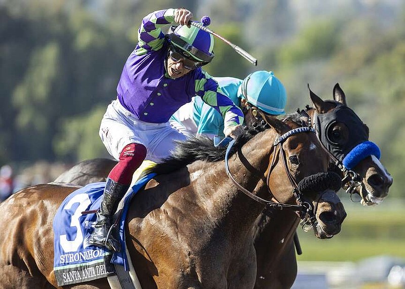 In a photo provided by Benoit Photo, Stronghold and jockey Antonio Fresu, outside, overpower Imagination, with Lanfranco Dettori, to win the Grade I, $750,000 Santa Anita Derby horse race Saturday, April 6, 2024, at Santa Anita in Arcadia, Calif. (Benoit Photo via AP)