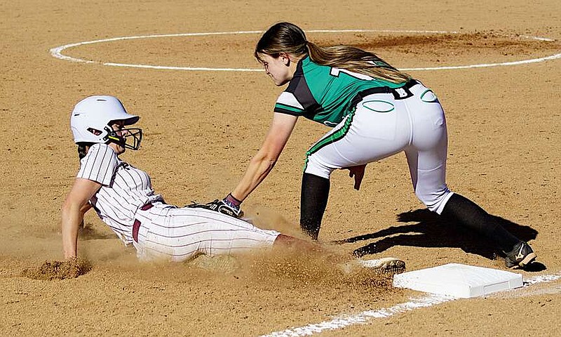 Randy Moll/Westside Eagle Observer
Gentry's Evey Tomlinson is tagged as she slides into third base during Gentry's home game on Thursday against Van Buren.