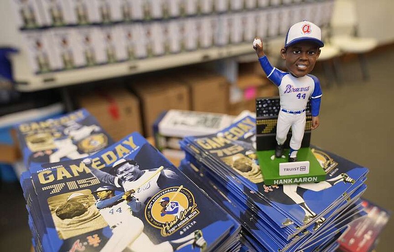 A Hank Aaron bobblehead commemorating the 50th anniversary of Aaron breaking Babe Ruth's career home run record is shown before a baseball game between New York Mets and Atlanta Braves Monday, April 8, 2024, in Atlanta. Aaron hit his 715th home run on April 8, 1974. (AP Photo/John Bazemore)