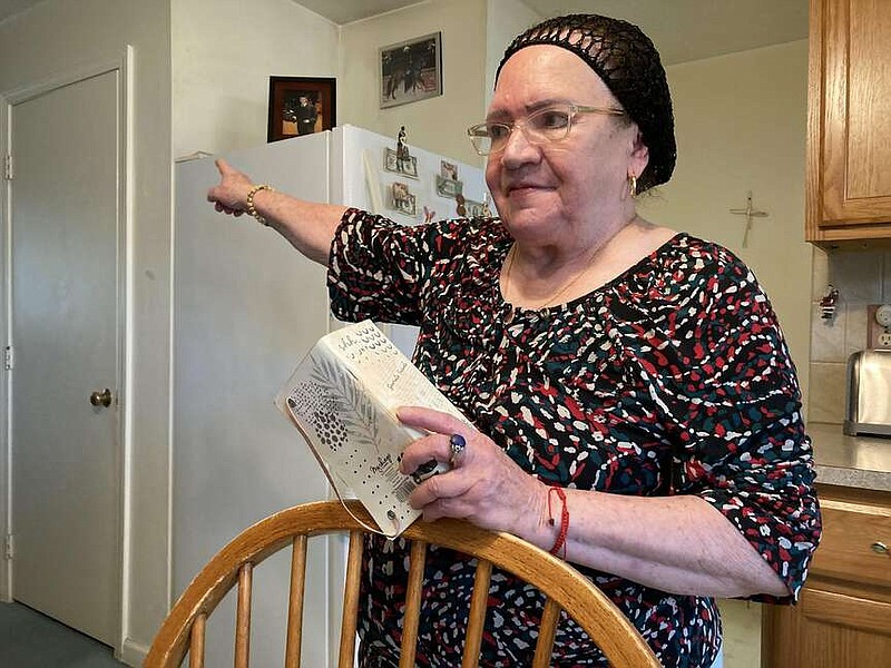 Piedad Fred, in her kitchen in Providence, R.I., recounts a frustrating visit to a community health center after she injured her knee. (TNS/Lynn Arditi/The Public's Radio)�