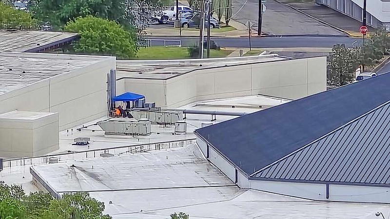 Electricians work on a portion of the Hot Springs Convention Center's electrical system via its roof Tuesday. An overnight storm knocked out the power to the facility around 1:30 a.m., according to Visit Hot Springs CEO Steve Arrison. (The Sentinel-Record/Donald Cross)
