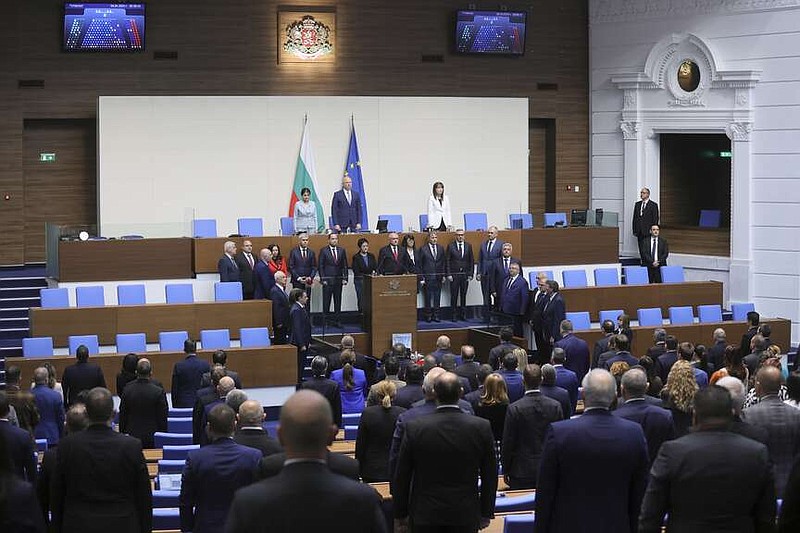 Dimitar Glavchev, new Bulgarian Prime Minister, center, and his interim government take their oath during a ceremony at the Bulgarian Parliament in Sofia, Bulgaria, Tuesday, April 9, 2024. Bulgaria's parliament on Tuesday formally approved an interim government, to run the EU member country until snap parliamentary and regular European Parliament elections on June 9. (AP Photo/Valentina Petrova)