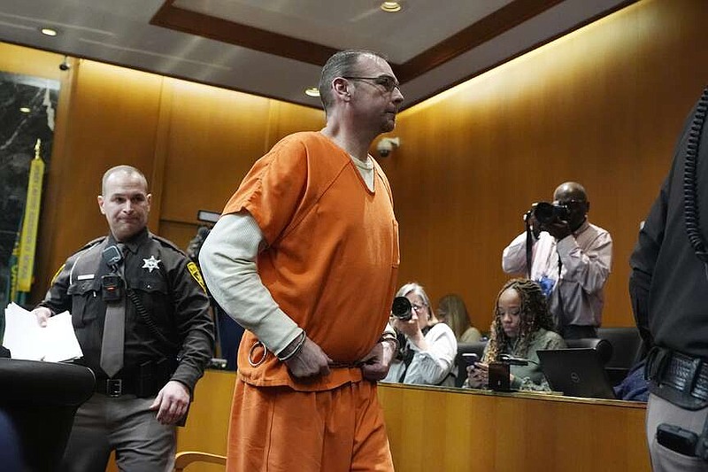 James Crumbley is escorted out of court after his sentencing, Tuesday, April 9, 2024, in Pontiac, Mich. James and Jennifer Crumbley, the parents of a Michigan school shooter, were sentenced to at least 10 years in prison Tuesday for failing to take steps that could have prevented the killing of four students in 2021.  (AP Photo/Carlos Osorio)