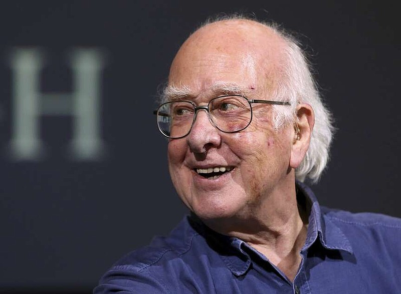 FILE - Britain's Professor Peter Higgs smiles during a press conference in Edinburgh, Scotland, on Oct. 11, 2013. The University of Edinburgh says Nobel prize-winning physicist Peter Higgs, who proposed the existence of the Higgs boson particle, has died at 94. Higgs predicted the existence of a new particle — the so-called Higgs boson  — in 1964. But it would be almost 50 years before the particle's existence could be confirmed at the Large Hadron Collider. Higgs won the 2013 Nobel Prize in Physics for his work, alongside Francois Englert of Belgium. (AP Photo/Scott Heppell, File)