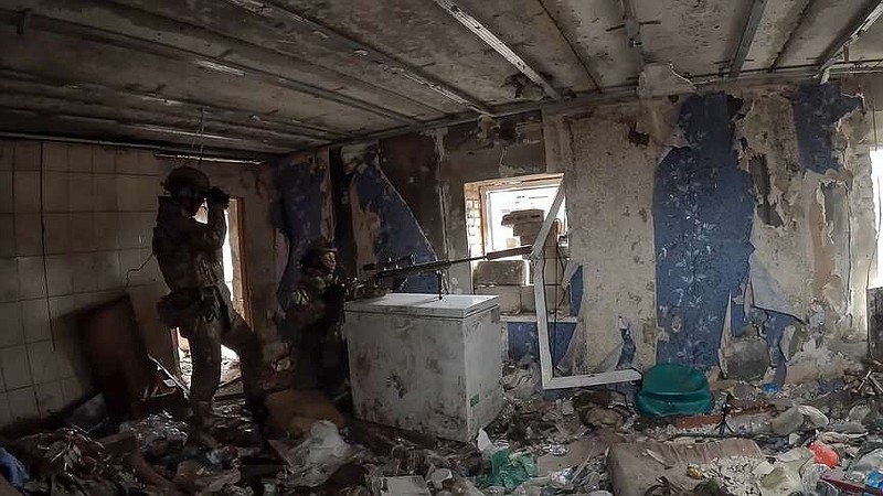In this photo taken from video released by the Russian Defense Ministry Press Service on Tuesday, April 9, 2024, a Russian sniper sits at the position in an undisclosed location in Ukraine. (Russian Defense Ministry Press Service via AP)