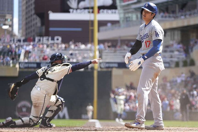 Los Angeles Dodgers designated hitter Shohei Ohtani (17) reacts after being tagged out at home plate by Minnesota Twins catcher Christian Vázquez to end the top of the seventh inning of a baseball game Wednesday, April 10, 2024, in Minneapolis. (AP Photo/Abbie Parr)