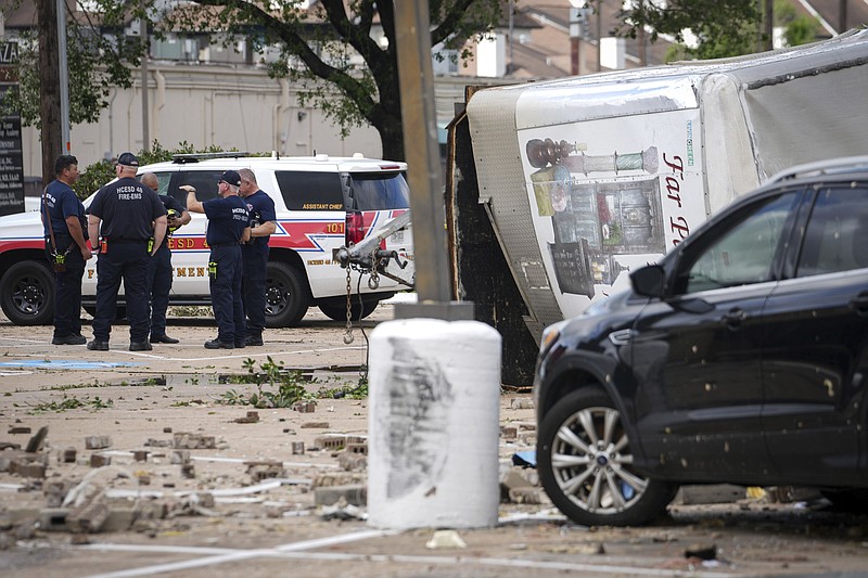 Authorities work the scene where a tornado damaged several businesses Wednesday, April 10, 2024, in Katy, Texas. (Jon Shapley/Houston Chronicle via AP)