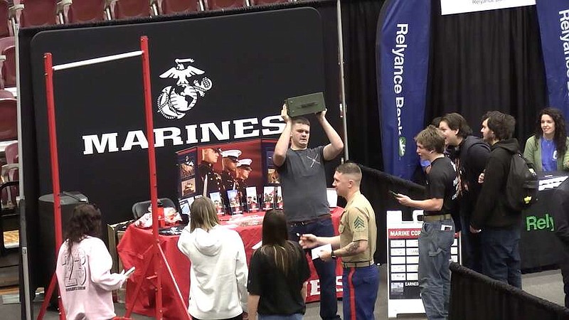 Students gather at the U.S. Marines recruiting booth in Wolf Arena on the Lake Hamilton campus during the 2023 Draft Day event in April 2023. (The Sentinel-Record/File photo)