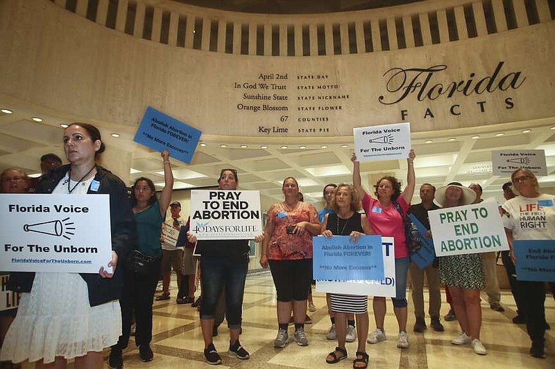 Supporters of Florida Voice For The Unborn demonstrate outside the fourth floor as legislators work on property insurance bills May 24, 2022, at the state Capitol in Tallahassee, Fla. The Florida Supreme Court ruled Monday, April 1, 2024, that a ballot measure to enshrine the right to abortion in the state constitution can go before voters in November. (AP Photo/Phil Sears, File)