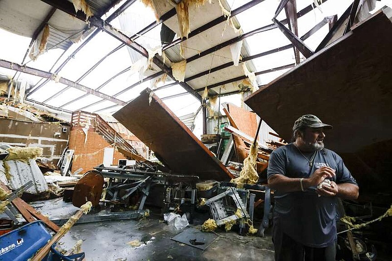 Lynn Champagne of E.C.O. Builders surveys the damage after the building was struck by an apparent tornado in south Slidell, La., Wednesday, April 10, 2024. (Scott Threlkeld/The Times-Picayune/The New Orleans Advocate via AP)