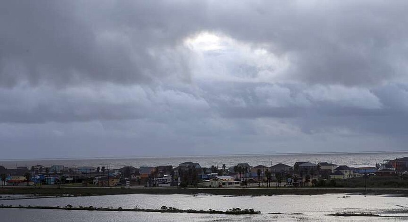 FILE - Sunshine makes its way through a break in the clouds on Sept. 22, 2020, in Surfside Beach, Texas. President Joe Biden's administration has approved construction of The Sea Port Oil Terminal, a deepwater oil export terminal off the Texas coast that would be the largest of its kind in the United States. Environmentalists called the move a betrayal of Biden's climate agenda and said  would lead to planet-warming greenhouse gas emissions equivalent to nearly 90 coal fired-power plants.(Godofredo A. Vasquez/Houston Chronicle via AP, File)
