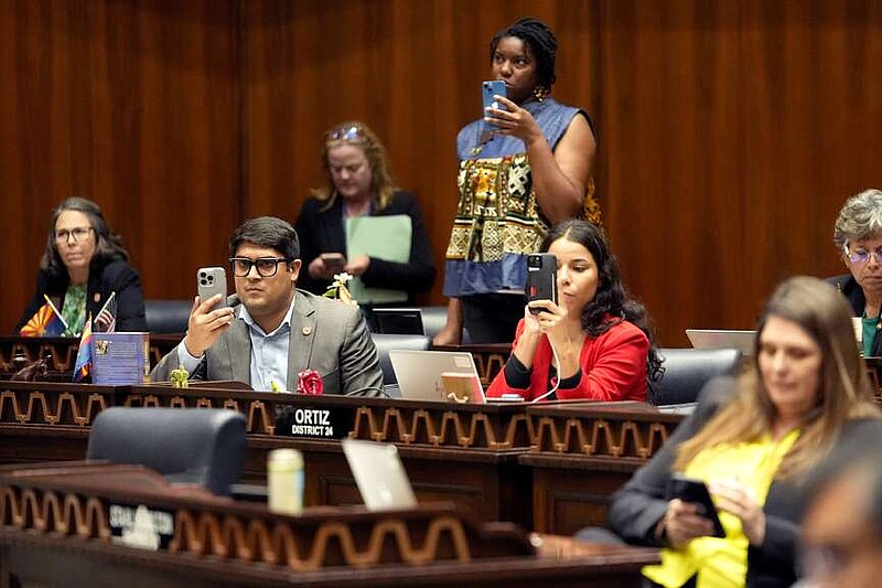 Democratic lawmakers record Arizona State Rep. Teresa Martinez, R, as she speaks from the House floor at the Capitol, Wednesday, April 10, 2024, in Phoenix. The Arizona Supreme Court ruled Tuesday that the state can enforce its long-dormant law criminalizing all abortions except when a mother's life is at stake. (AP Photo/Matt York)
