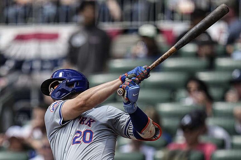 New York Mets first base Pete Alonso (20) hits a base hit during the second inning of a baseball game agaimnst the Atlanta Braves, Thursday, April 11, 2024, in Atlanta. (AP Photo/Mike Stewart)