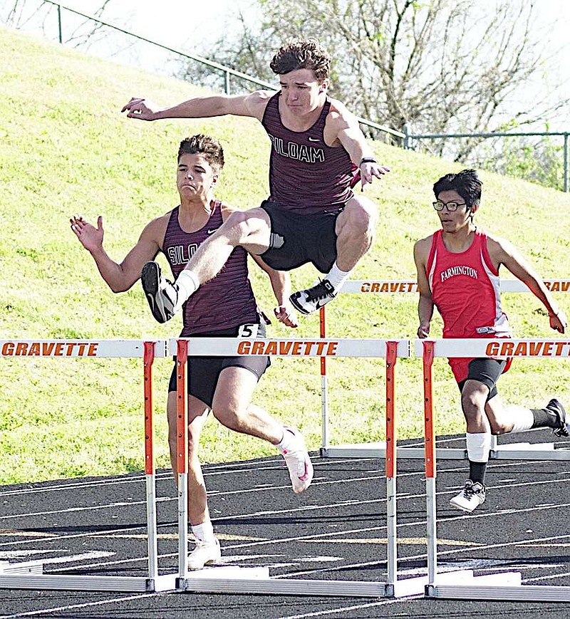 Photograph courtesy of Randy Moll/Westside Eagle Observer
Siloam Springs runners Gage Jones, left, and Grayson Manning, center, compete in the Gravette Lion Invitational on April 11.