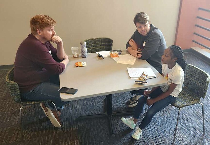 A'miya Louden, a third-grader at Martin Luther King Jr. Elementary School in Little Rock, works with actor Matt Maguire (left) and dramaturg Austin Rodgers on her script for a short play at the Arkansas Repertory Theatre.

(Special to the Democrat-Gazette/Tamra Patterson Calamese)