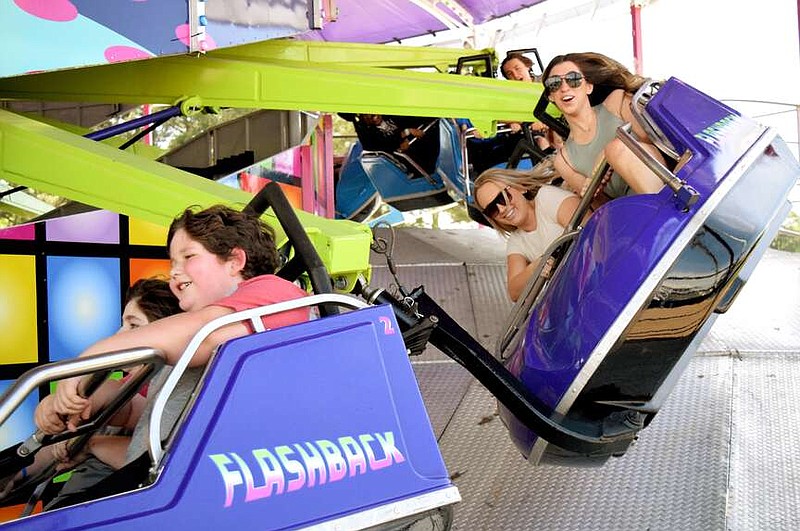 Fairgoers enjoy a spin on the Flashback during the 79th annual Four States Fair and Rodeo on Saturday afternoon, April 6, 2024, at Four States Fairgrounds in Texarkana, Ark. The fair concludes Sunday, April 14. (Staff photo by Stevon Gamble)