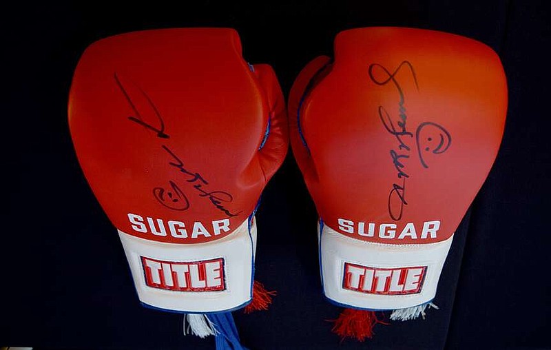 A pair of boxing gloves autographed by six-time champion Sugar Ray Leonard are seen just outside the conference room at Texarkana Convention Center on Thursday, April 11, 2024, in Texarkana, Texas. Leonard was the featured lecturer at the fourth annual Farmers Bank Distinguished Speaker Series. Four sets of gloves were raffled during the event. (Staff photo by Stevon Gamble)