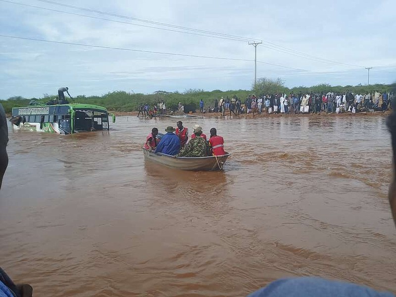 Passengers of a bus that was swept away by floodwaters are rescued by boat, near Garissa, northern Kenya, Tuesday, April 9, 2024. Police said some of the passengers managed to escape just before the bus was submerged, while others climbed onto the roof. The incident happened just hours after Kenya's roads agency announced the closure of another section of the same road that was flooded after the Tana River swelled due to continuing heavy rains. (AP Photo)