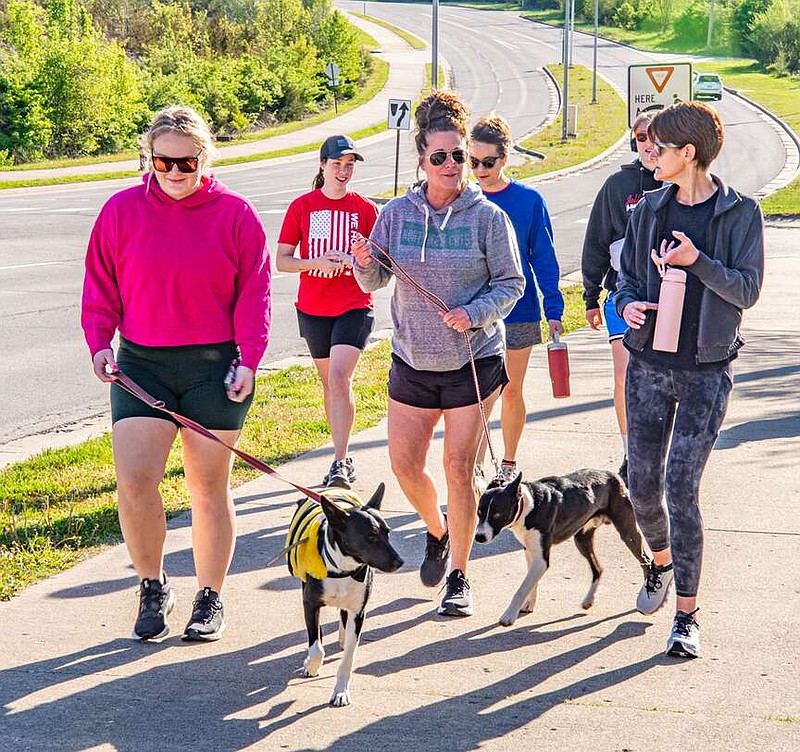 Ken Barnes/News Tribune
From left, Ryliegh Case with Porter, Jeanne Case with Scooter, and Nichole Genovese take off in Saturday's K9s on the Front Line 5K Saturday.