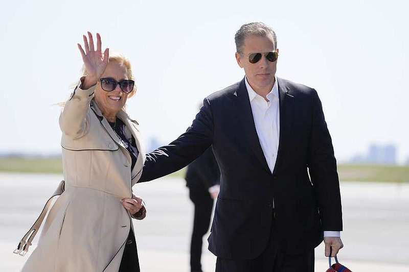 First lady Jill Biden waves as she walks with son Hunter Biden, to board Air Force One at John F. Kennedy International Airport, Friday, March 29, 2024, in New York. (AP Photo/Alex Brandon)